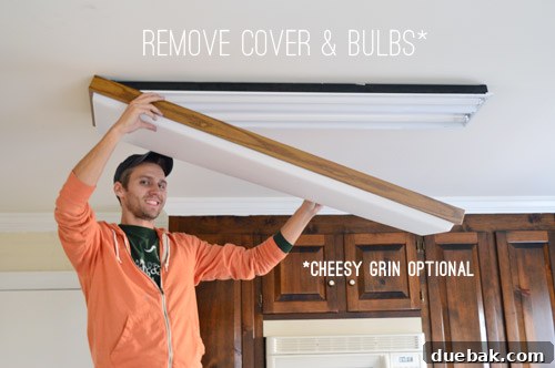 Upgrade Your Lighting: Swapping Fluorescent Fixtures for Pendants 3 John removing fluorescent light plastic cover
