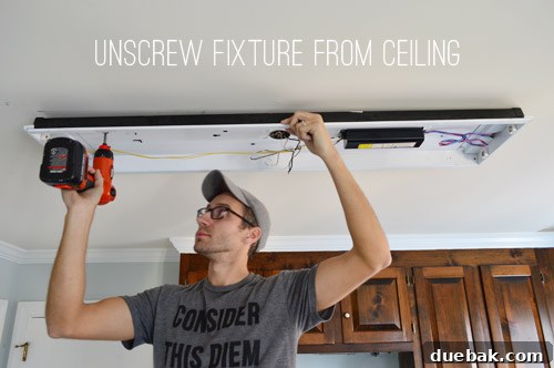 Upgrade Your Lighting: Swapping Fluorescent Fixtures for Pendants 6 John uninstalling kitchen fluorescent light with screwdriver