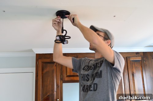 Upgrade Your Lighting: Swapping Fluorescent Fixtures for Pendants 10 John connecting pendant light fixture to ceiling where fluorescent light fixture used to be
