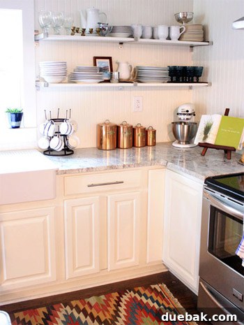 Detail shot of the kitchen, highlighting the farmhouse sink, beadboard walls, and copper accents.