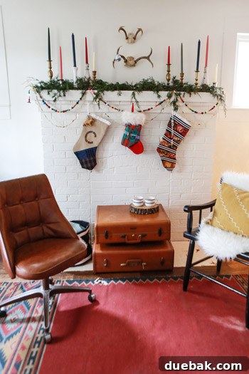 Close-up of the lounge area showcasing the $5 Navajo print rug, colorful candles, and stacked suitcases.