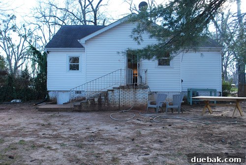Before photo of the backyard, showing just dirt before the patio transformation.
