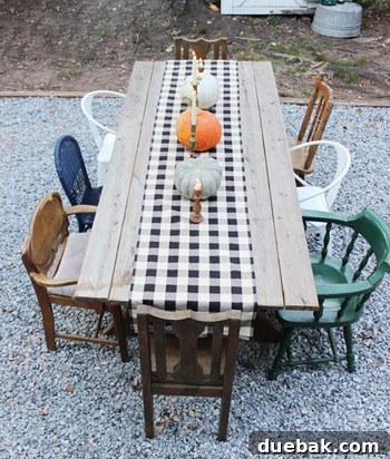 Eclectic outdoor dining area with a mix of thrifted chairs around a handmade picnic table.