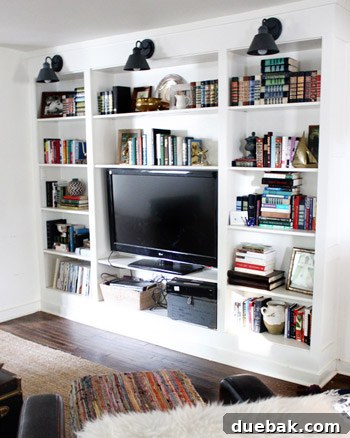 After photo of the living room, featuring new built-in bookshelves replacing the old laundry closet.