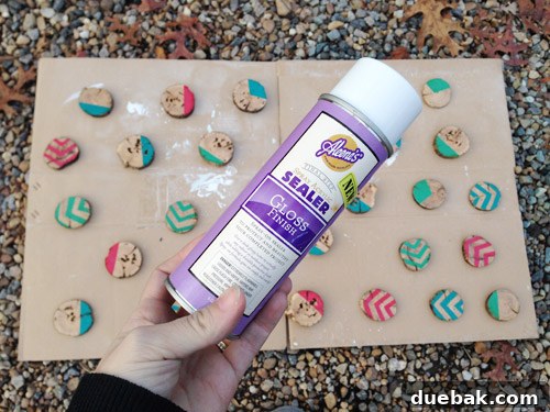 Rustic Wood Slice Christmas Creations 12 Applying a gloss sealer to painted wood slice ornaments outdoors