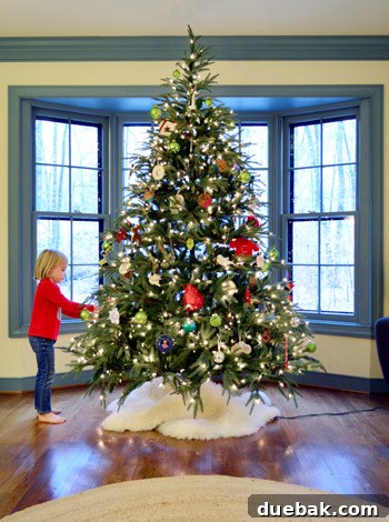 Rustic Wood Slice Christmas Creations 17 Tall artificial Christmas tree standing in a bay window