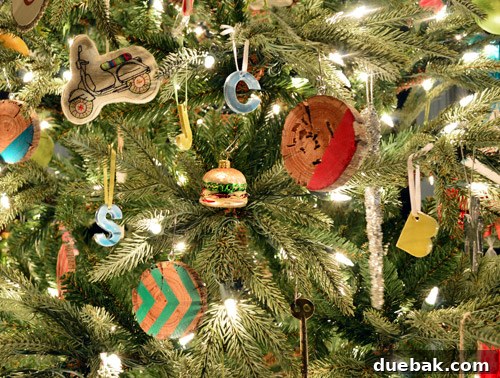 Rustic Wood Slice Christmas Creations 25 Whimsical ornaments, including a tiny tin hamburger, on a Christmas tree