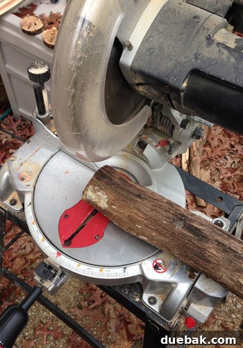 Rustic Wood Slice Christmas Creations 7 Close-up of a miter saw cutting a branch into wood slices