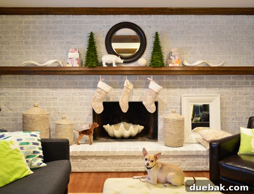 Close-up of a Christmas stocking with a small cardboard dog figurine wearing a sherpa hat and carrying a tiny present.
