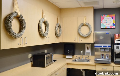 Brightening Little Lives: Our Holiday Hospital Makeover 16 Wreaths Hanging On Hospital Kitchen Shelving, adding festive touches to a functional area.