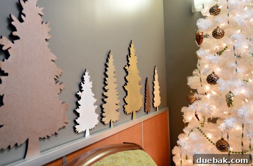Brightening Little Lives: Our Holiday Hospital Makeover 6 Wood Cut Christmas Trees In Different Sizes And Bronze Gold Spray Paints, showing the DIY process for the metallic tree forest.