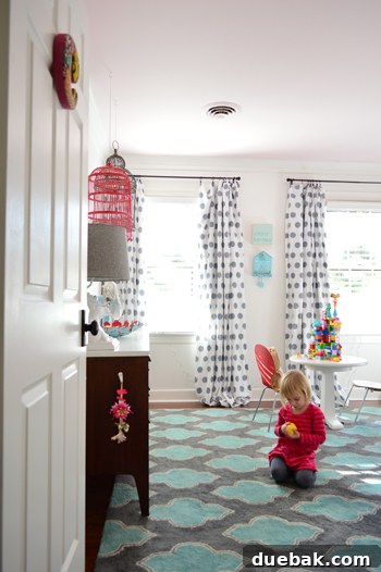Clara's room, showing the newly decorated play wall from a distance, with other room elements visible.
