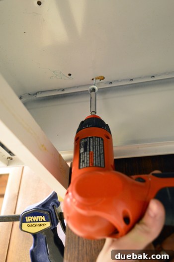 Replacing an Over-the-Range Microwave with a Range Hood 12 Inside view of a range hood, showing the screw and washer securing mechanism