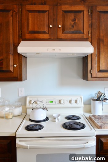 Replacing an Over-the-Range Microwave with a Range Hood 14 The newly installed white range hood above a kitchen stove, enhancing the kitchen's appearance