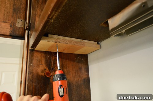 Replacing an Over-the-Range Microwave with a Range Hood 8 Custom wood blocks installed under a cabinet to create a flush mounting surface for the hood