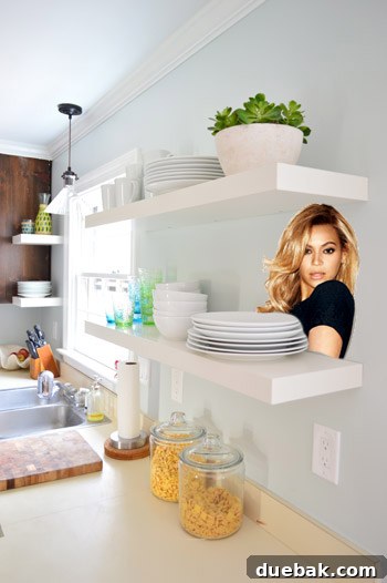 White IKEA LACK floating shelves beautifully integrated into our newly updated kitchen, with a humorous photoshop of Beyoncé on one shelf, adding a playful touch.