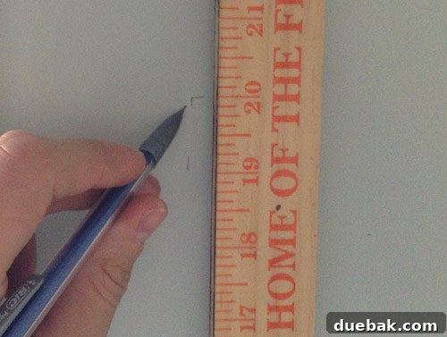 Utilizing a yardstick and pencil to accurately mark the height and placement of kitchen floating shelves, ensuring proper alignment.