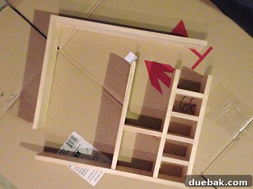 The second row of horizontal shelves and vertical dividers being added to the DIY figurine cubby.