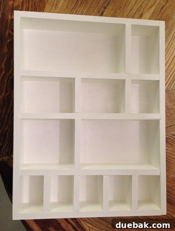 The white-painted DIY figurine cubby, clean and ready for fabric customization.