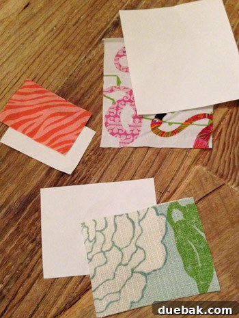 Paper templates cut to the size of cubby compartments, lying on fabric swatches, ready for precise cutting.