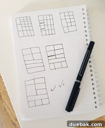 Initial sketch of a multi-compartment wall shelf design, showing varied cubby sizes, drawn on paper.