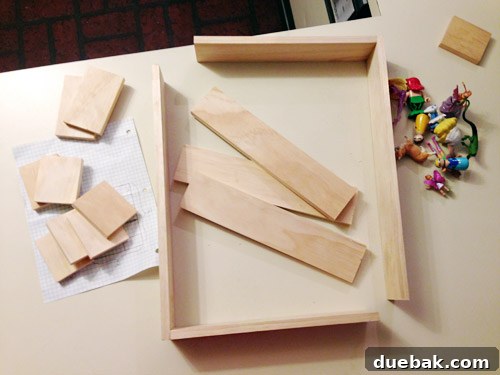 Wooden craft boards cut into various sizes, laid out on a workbench, ready for assembly into a cubby shelf.