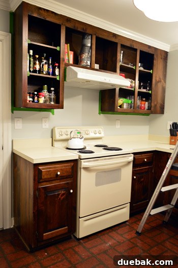 Effortlessly Transform Your Kitchen with White Upper Cabinets 8 Kitchen frames taped off and ready for primer application.