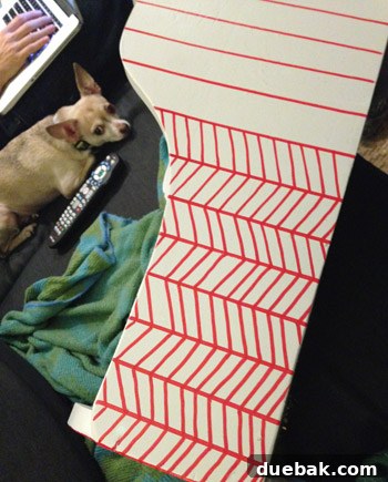 Process photo showing freehand diagonal lines connecting the previously drawn vertical lines on the cradle.
