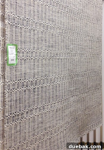Large 100% wool rug with a subtle pattern on the floor of HomeGoods