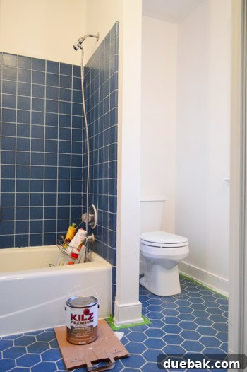 Our Bathroom's Wallpaper Detox 15 Bathroom with freshly primed and painted white trim and quarter-round, making the room look brighter.