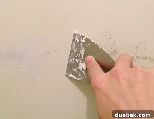 Our Bathroom's Wallpaper Detox 10 Wall with numerous small spackle patches applied to fill imperfections.