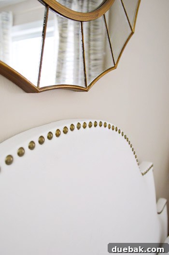 Chic white ceramic lamps on brass side tables in Carrie's updated bedroom