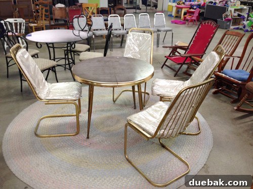 Kitchen's Gilded Past 3 Four vintage wire chairs with plastic-wrapped covers, awaiting a rustic modern kitchen transformation.