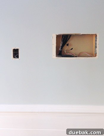 Artful Appetites 12 The kitchen wall with the phone jack covered and the intercom hole concealed by art.