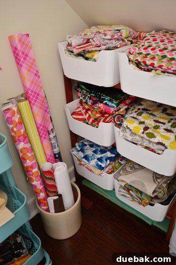 Organized fabric in bins on a wooden shelf in the closet