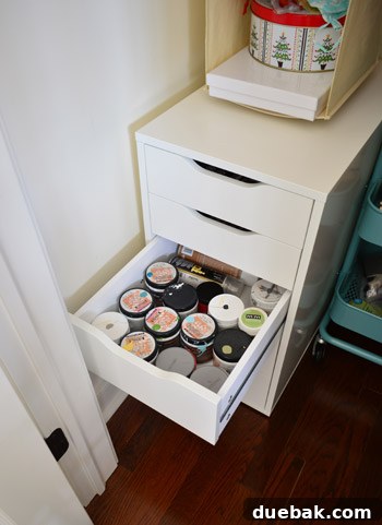 Third drawer organized with paint test pots and spray sealers