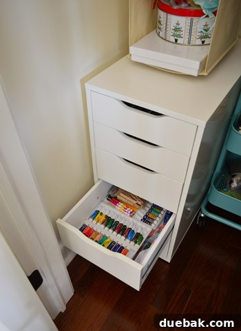Fourth drawer organized with fine art supplies like oil paints and charcoals
