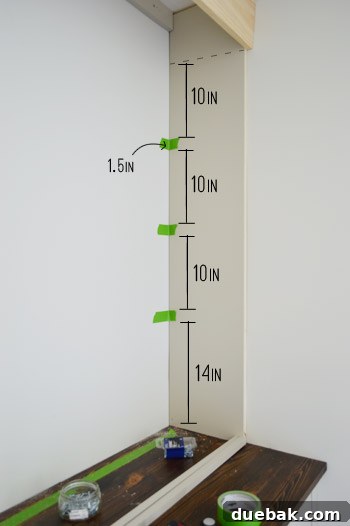 Craft Your Own Library Haven 11 Detailed measurements marked with painter's tape on a DIY bookshelf frame, illustrating precise shelf spacing and planning.
