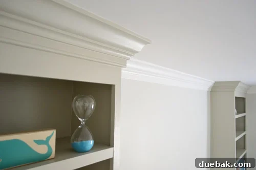 Craft Your Own Library Haven 17 Finished top of a built-in bookshelf with elegant crown molding, showcasing a polished and integrated look.