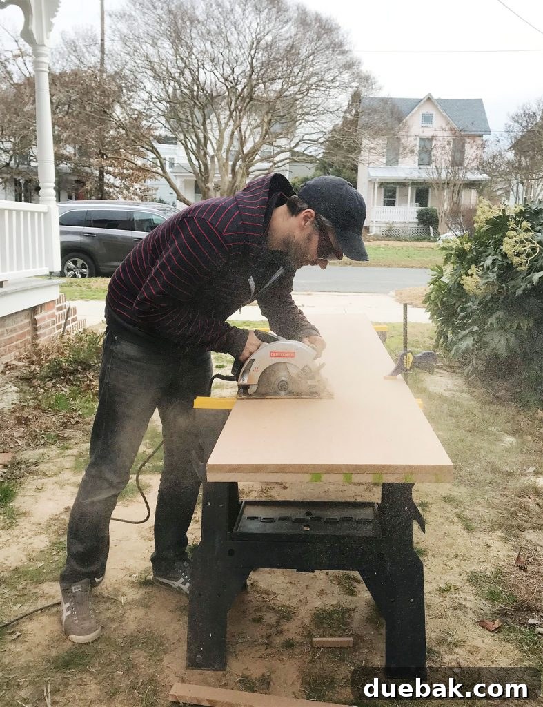 Craft Your Own Library Haven 6 A person meticulously cutting a large sheet of MDF using a circular saw with a guide, ensuring a straight and precise cut for shelving components.
