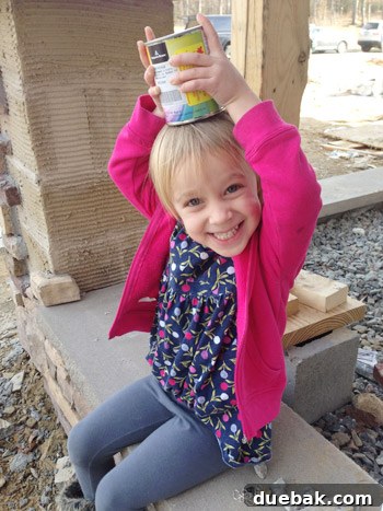 Child helping mix paint test pots