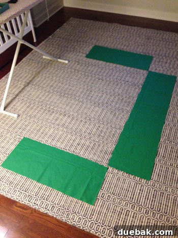 Fabric laid out for cutting crib skirt panels, showing pattern alignment