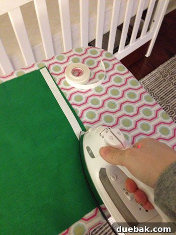 Applying Heat N' Bond hem tape to fabric panels for a no-sew crib skirt