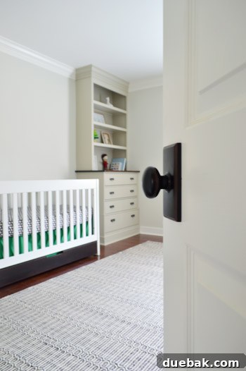 Crib with newly stained bottom drawer, matching the nursery's color scheme