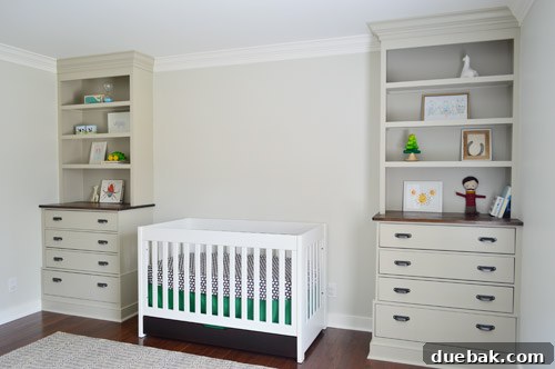 Nursery built-in bookcases with temporary decor, awaiting full styling