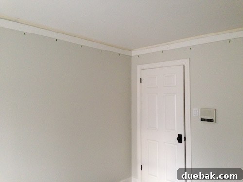 Installing the first layer of crown molding using baseboard