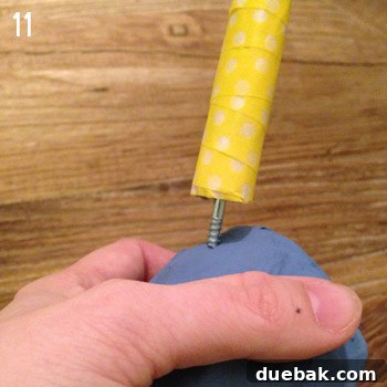 The narwhal tusk being screwed into the paper mache head