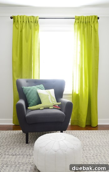 Close-up of the apple green curtain fabric showing a thick hem and developing pleats.