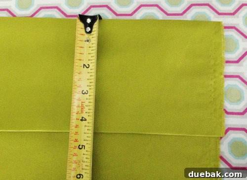 Folding curtain fabric to create a substantial 4.5-inch cuff for the top and bottom hems.