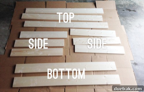 Cut wooden boards laid out on a garage floor, ready for assembly.